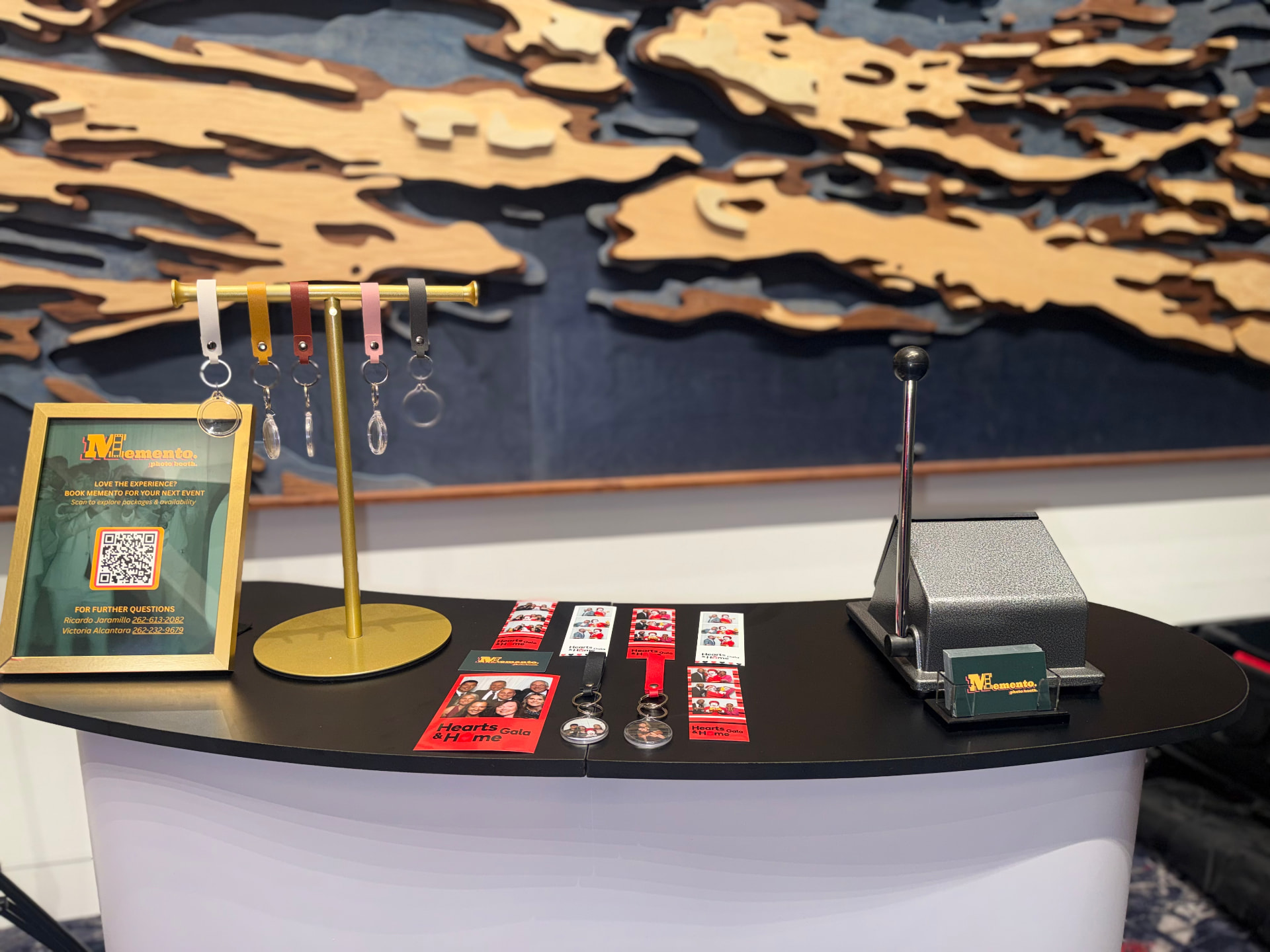 Memento Photo Keychain Station with personalized photo keychains, photo strips, and keychain press at an event