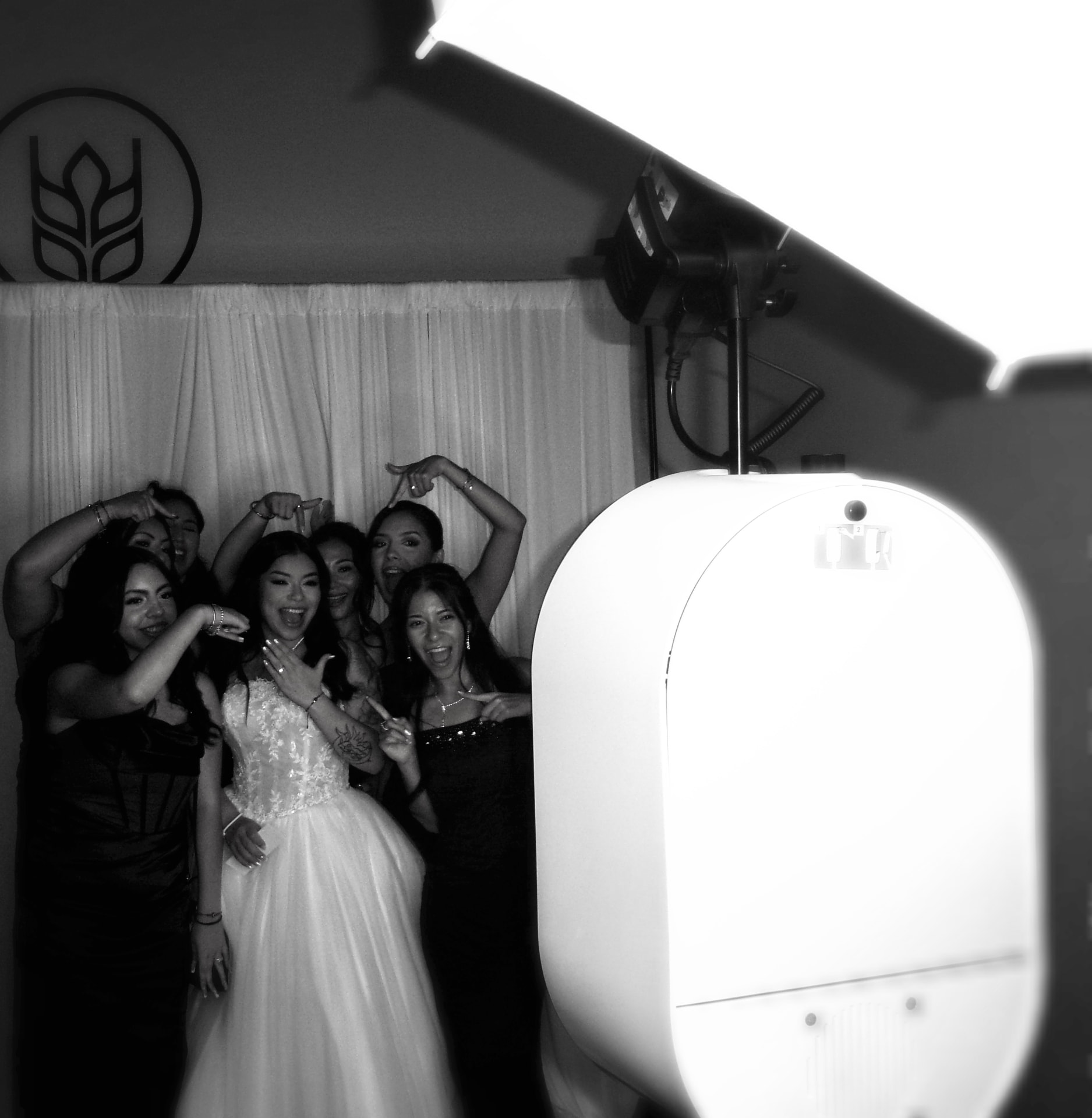 A bride and friends celebrating in the Memento photo booth